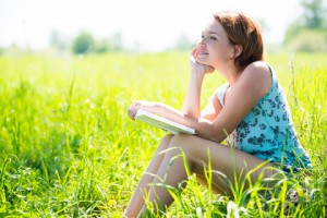 http://www.dreamstime.com/royalty-free-stock-photo-pretty-smiling-woman-book-nature-looking-away-image31793635